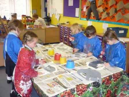 Year R painting 'Elmer' for their display board